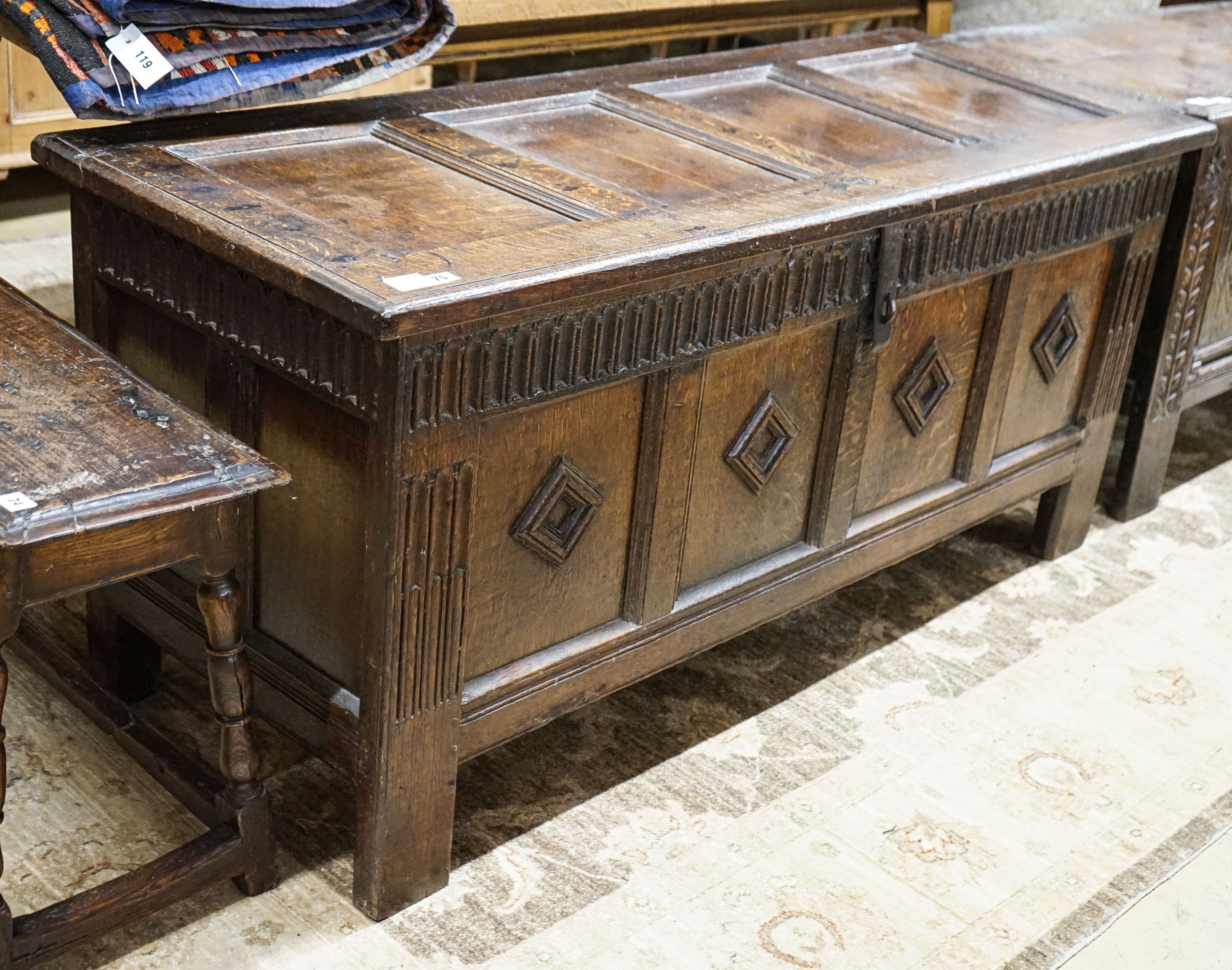 A late 17th century oak coffer, with four panel top and carved front, length 151cm, depth 58cm, height 69cm